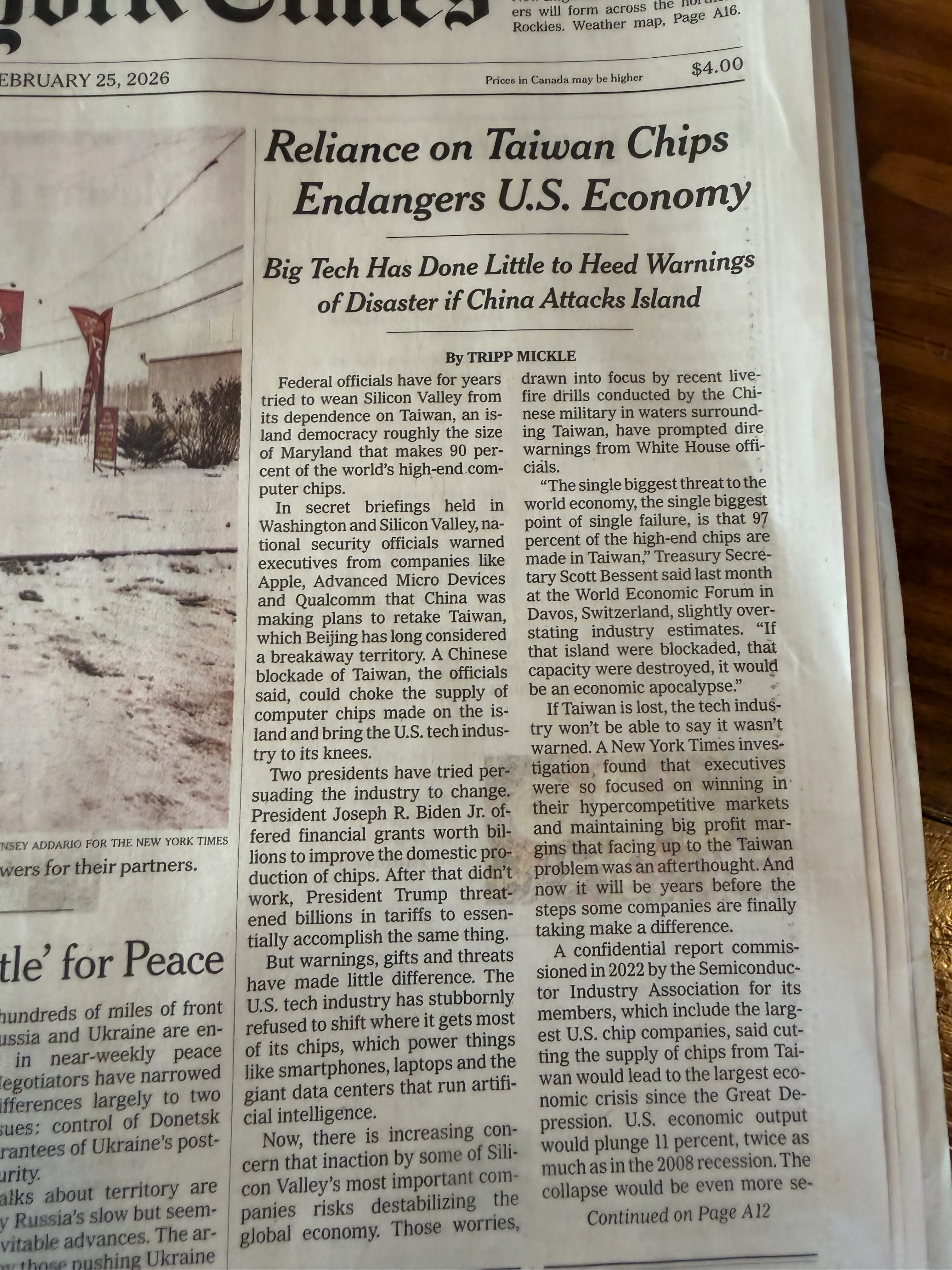 A paper copy of the New York Times sitting on a wooden countertop